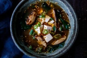 20-minute Miso Soup Recipe with shiitake mushrooms, wilted greens, and tofu makes for a fast and easy weeknight dinner. Full of flavor and nutrients it is highly nourishing while remaining light and lean. Vegan and GF adaptable. 