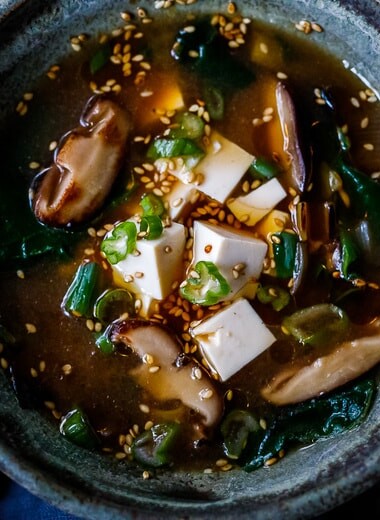 20-minute Miso Soup Recipe with shiitake mushrooms, wilted greens, and tofu makes for a fast and easy weeknight dinner. Full of flavor and nutrients it is highly nourishing while remaining light and lean. Vegan and GF adaptable. 