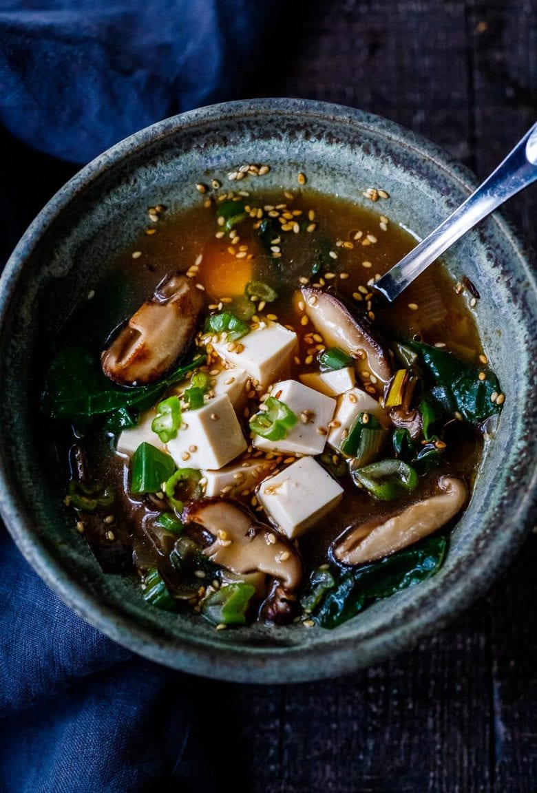 20-minute Miso Soup Recipe with leeks, shiitake mushrooms, wilted greens, and tofu makes for a fast and easy weeknight dinner. Full of flavor and nutrients it is highly nourishing while remaining light and lean. Vegan and GF adaptable.