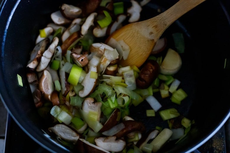 sautéing mushrooms and leeks in a heavy bottomed pot for miso soup