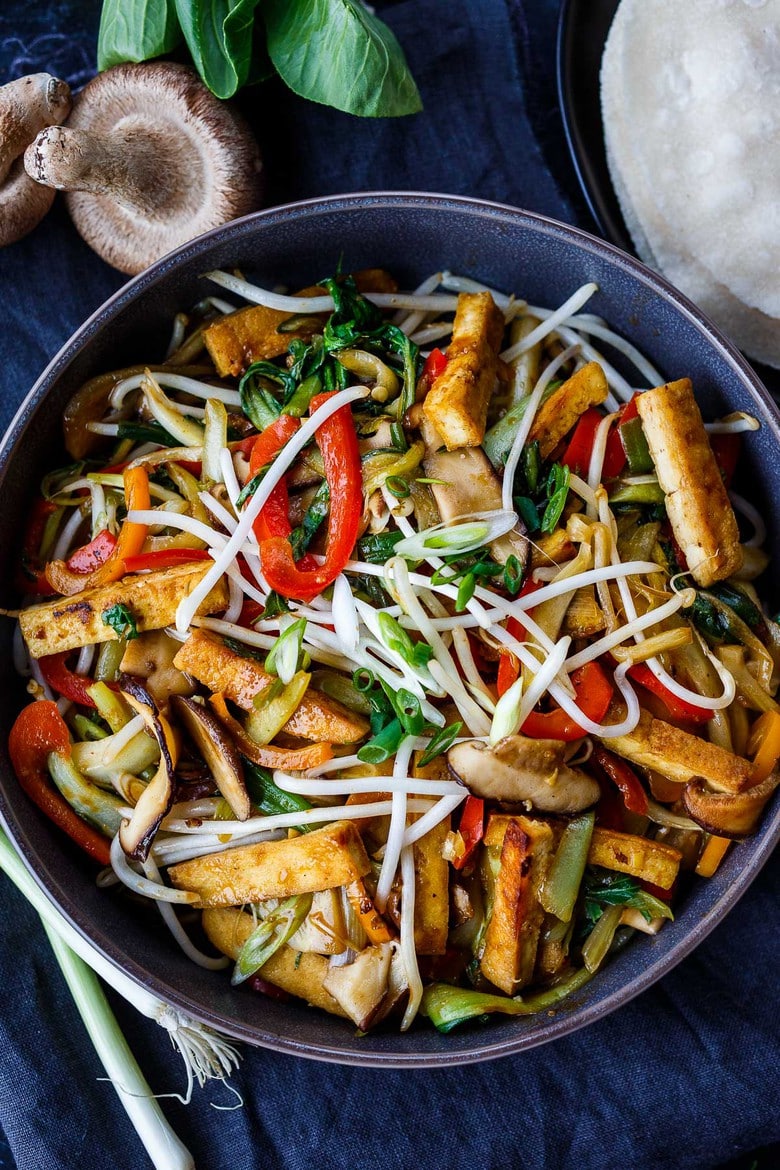 This Moo Shu Tofu recipe is loaded with tender-crisp vegetables and crispy tofu tucked into a tortilla or rice pancake, slathered with a tangy hoisin sauce.  A quick and easy weeknight dinner!  Vegan and Gluten-Free.