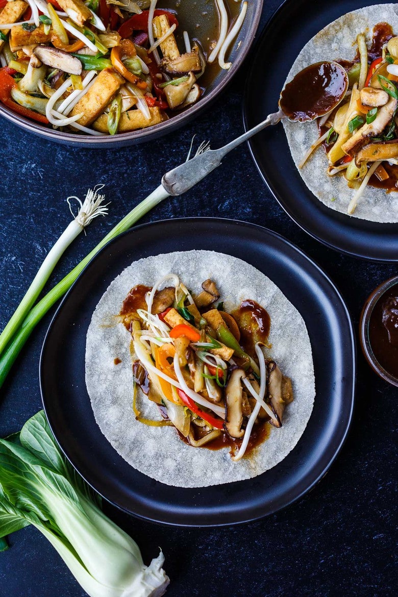 This Moo Shu Tofu recipe is loaded with tender-crisp vegetables and crispy tofu tucked into a tortilla or rice pancake, slathered with a tangy hoisin sauce.  A quick and easy weeknight dinner!  Vegan and Gluten-Free.