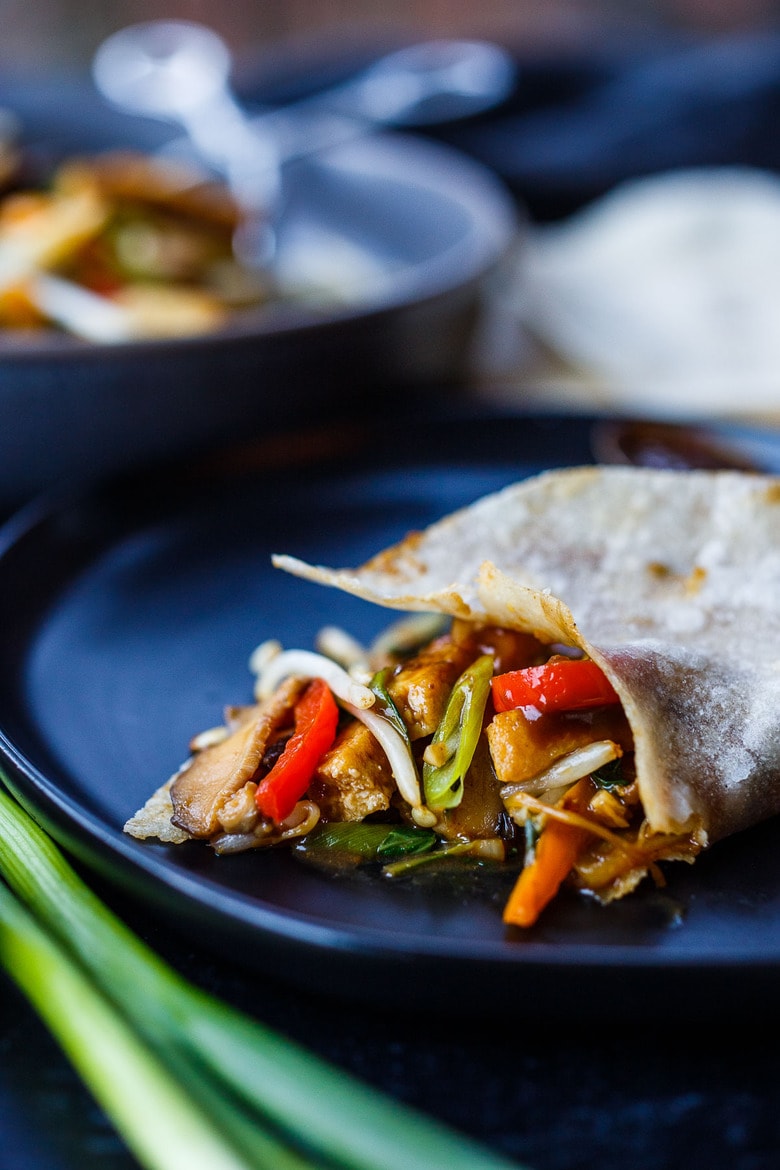 This Moo Shu Tofu recipe is loaded with tender-crisp vegetables and crispy tofu tucked into a tortilla or rice pancake, slathered with a tangy hoisin sauce.  A quick and easy weeknight dinner!  Vegan and Gluten-Free.