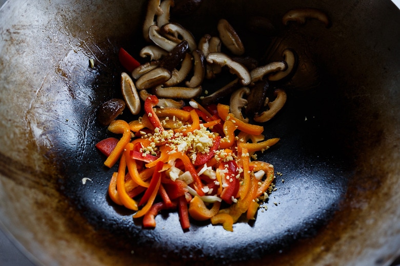 stir frying shiitakes and peppers