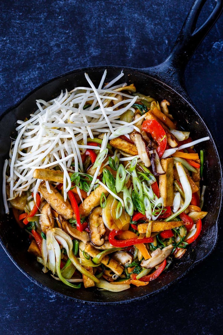 This Moo Shu Tofu recipe is loaded with tender-crisp vegetables and crispy tofu tucked into a tortilla or rice pancake, slathered with a tangy hoisin sauce.  A quick and easy weeknight dinner!  Vegan and Gluten-Free.