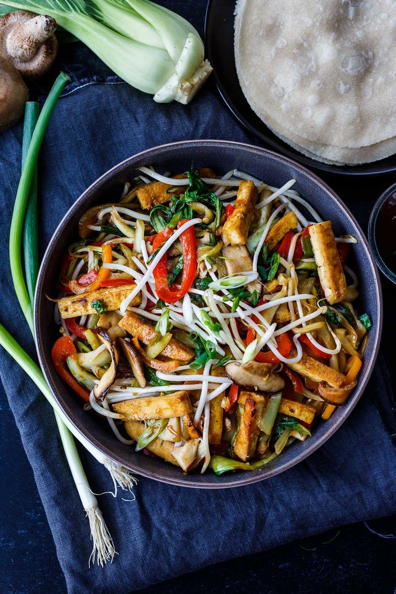 This Moo Shu Tofu recipe is loaded with tender-crisp vegetables and crispy tofu tucked into a tortilla or rice pancake, slathered with a tangy hoisin sauce.  A quick and easy weeknight dinner!  Vegan and Gluten-Free.