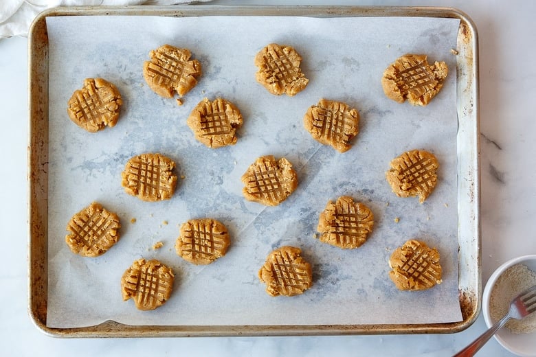 criss cross peanut butter cookies on a tray ready to bake