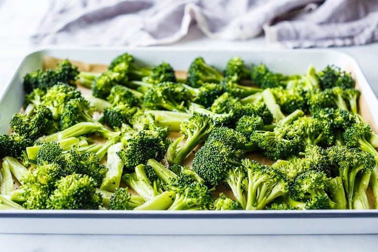 lay broccoli on a rimmed sheet pan with parchment