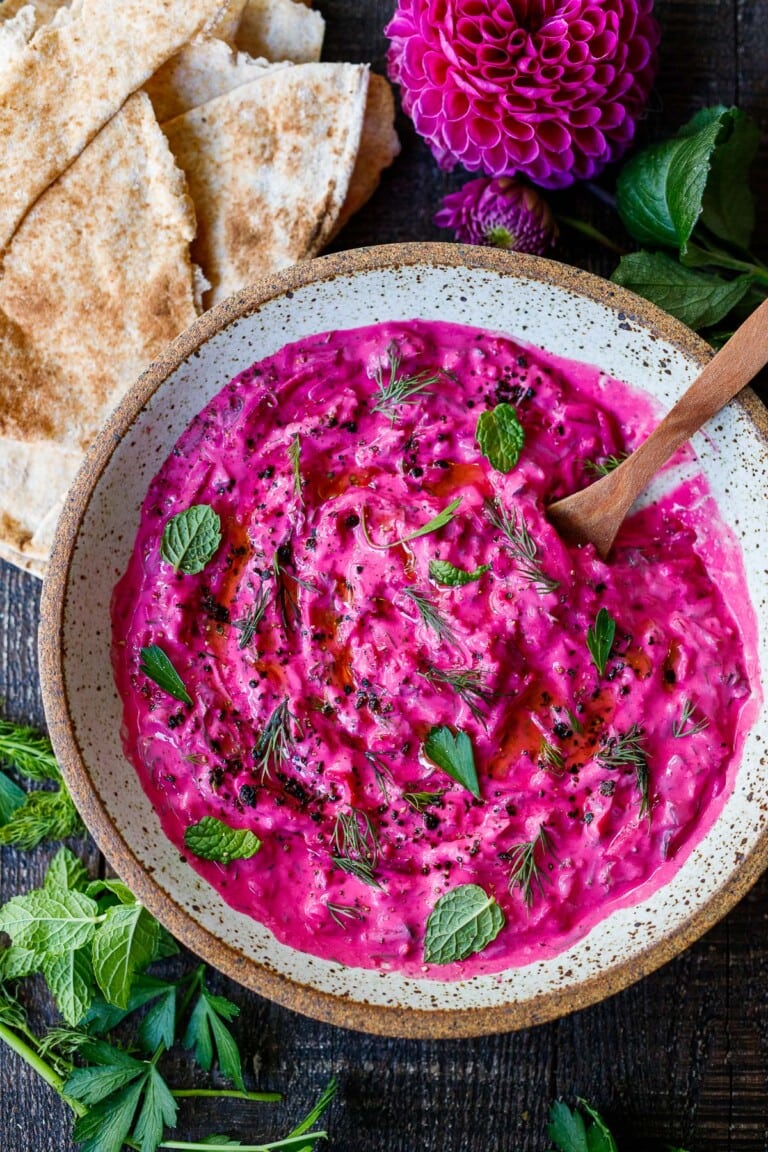 Vibrant Beet Tzatziki made with grated beets, cucumber, Greek yogurt and fresh herbs- a festive appetizer or complementary side dish to Mediterranean-inspired meals.  Vegan-adaptable!