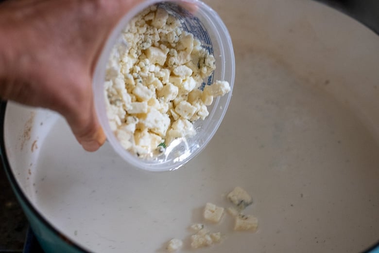 adding gorgonzola to the sauce