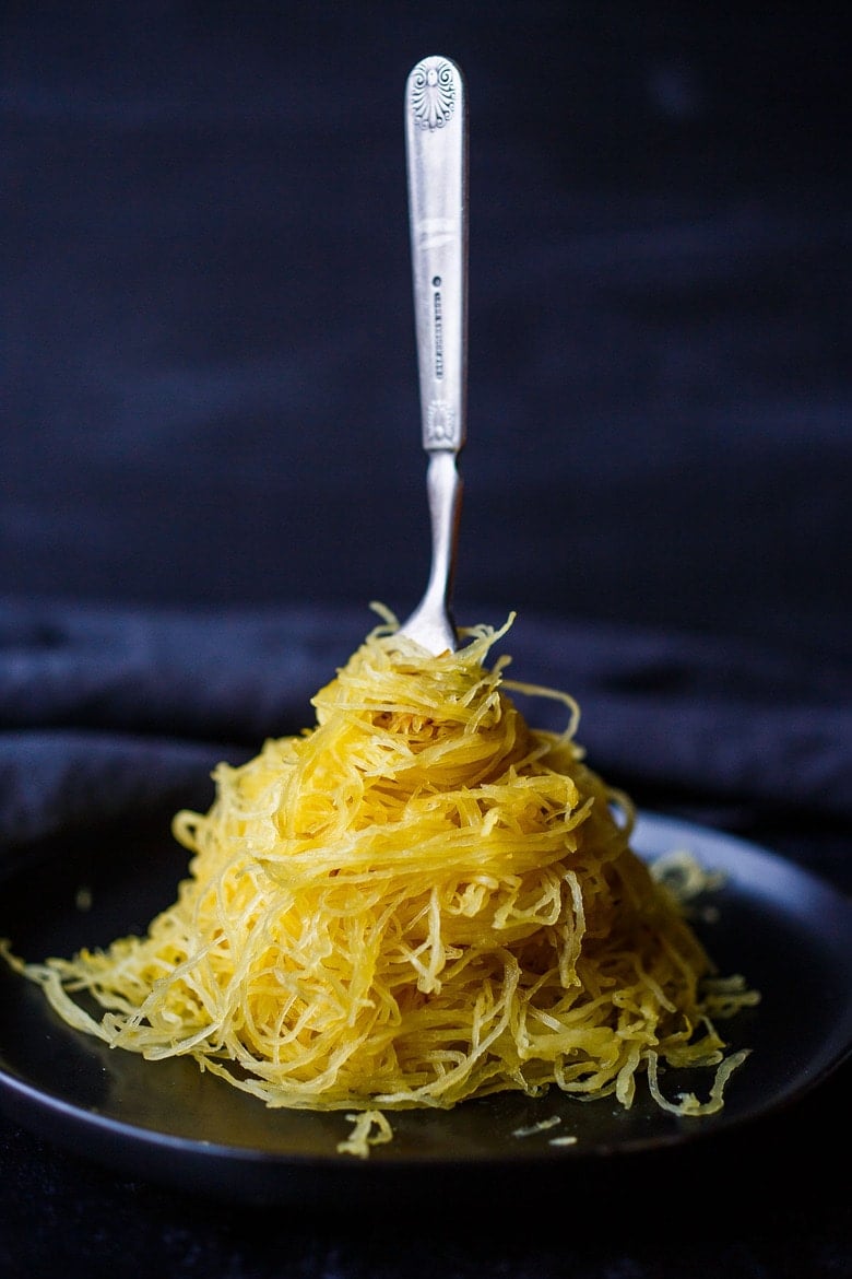 How to Cook Spaghetti Squash -a faster method that yields long spaghetti-like strands while delivering the BEST texture in the shortest amount of time. A perfect low-carb substitute for pasta or a simple side dish.  Versatile, highly nutritious, and easy to cook!