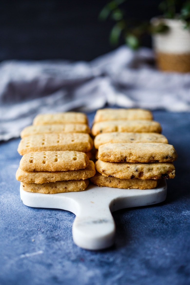 stacks of shortbread cookies on marble serving board.