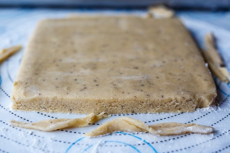 rolled out and trimmed shortbread cookie dough.