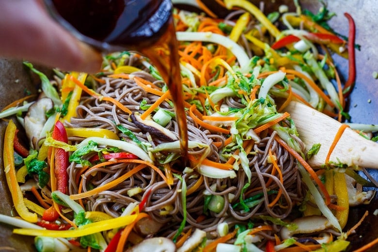 adding sauce to the noodles