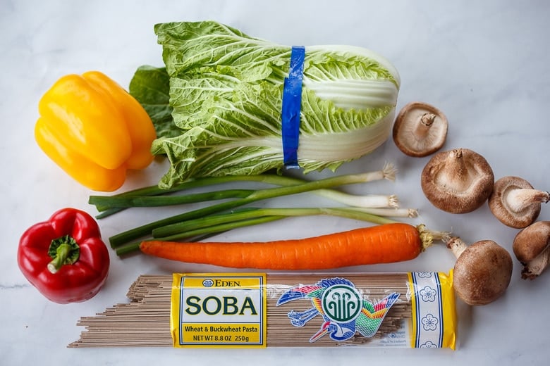 Ingredients in soba noodles: colorful bell peppers, napa cabbage, carrots, green onions, shiitake mushrooms, soba noodles.