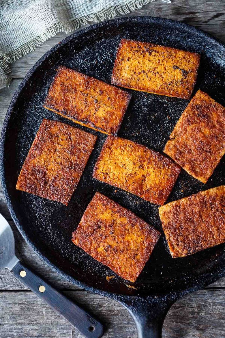 This smoky, crispy Vegan Bacon is made with tofu and is perfectly chewy and savory.  A delicious plant-based protein, perfect for breakfast, BLTs, wraps, sandwiches, pastas, and buddha bowls.