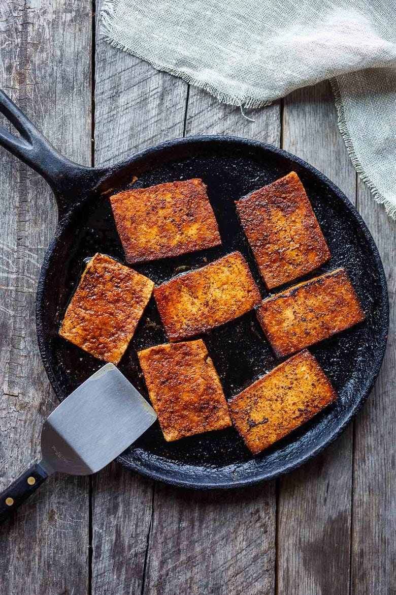 This smoky, crispy Vegan Bacon is made with tofu and is perfectly chewy and savory.  A delicious plant-based protein, perfect for breakfast, BLTs, wraps, sandwiches, pastas, and buddha bowls.