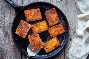 This smoky, crispy Vegan Bacon is made with tofu and is perfectly chewy and savory.  A delicious plant-based protein, perfect for breakfast, BLTs, wraps, sandwiches, pastas, and buddha bowls.