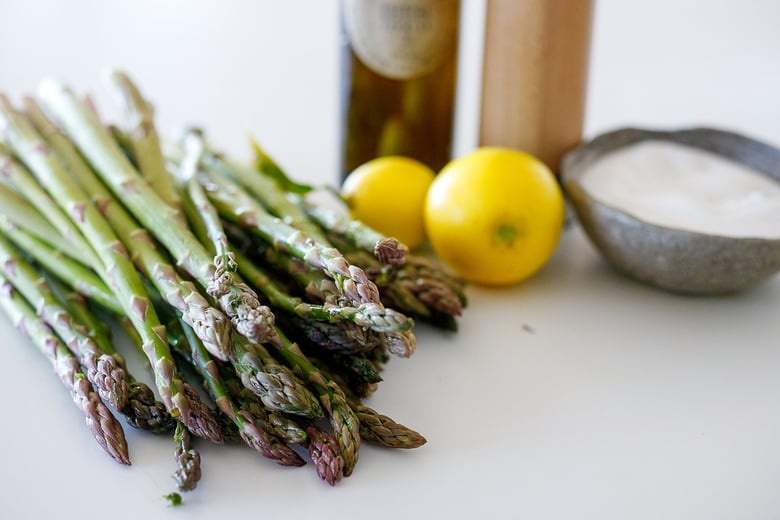 ingredeints in grilled asparagus- lemon, salt, pepper, olive oil and asparagus