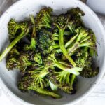 How to make Crispy Oven Roasted Broccoli - perfect as a simple side dish or use to enhance other dishes.  Baking in a hot oven yields tender-crisp broccoli in under 30 minutes. Fast and EASY Recipe!