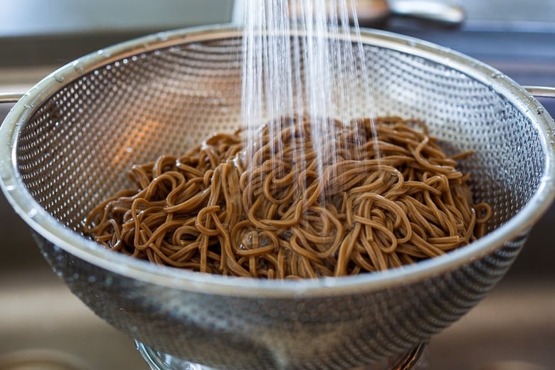 rinsing buckwheat soba noodles in plenty of cold water