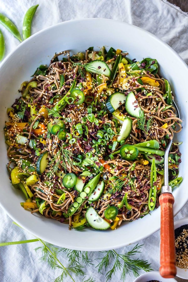 A simple recipe for Soba Noodle Salad, loaded with veggies, that is adaptable and vegan!  For a protein boost, top with savory baked tofu, smoked salmon, grilled chicken. A potluck idea favorite- we love our noodles!