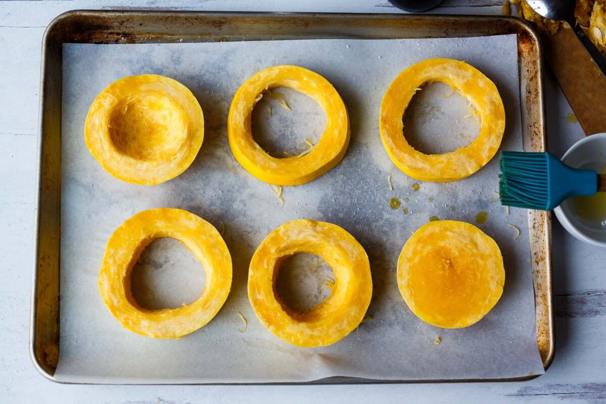 rings of spaghetti squash on a baking sheet.