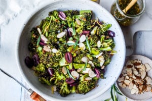 Easy Roasted Broccoli Salad with toasted almonds, kalamata olives, and lemon zest drizzled with Mustard Seed Maple Dressing.