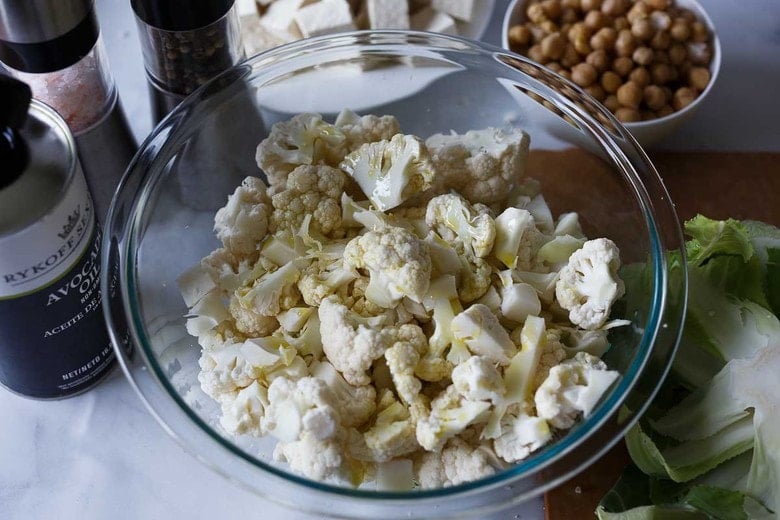 tossing cauliflower with olive oil