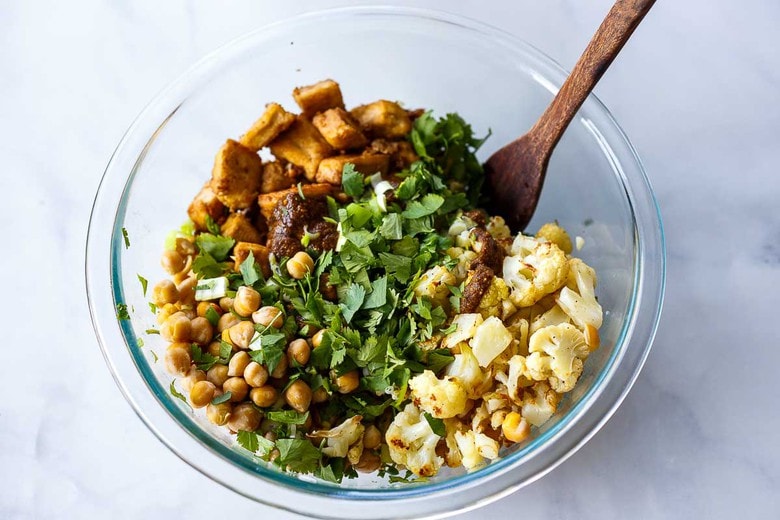 tossing all ingredients together with the dressing