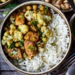 Savory oven-roasted Indian Cauliflower, Chickpea, and Tofu Bowls served over fluffy basmati rice with Cilantro Mint Chutney, seasoned with a simple Madras Curry dressing. A simple dish rich with fragrant spice and amazing flavor.  Healthy,  flavorful, and vegan! (Updated 4/22)