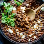 Savory Black Beans baked in a quick and easy Mexican Mole Sauce topped with queso fresco cheese (optional)- serve this as a delicious side dish for your Mexican Fiesta or as a flavorful base for healthy bowls.