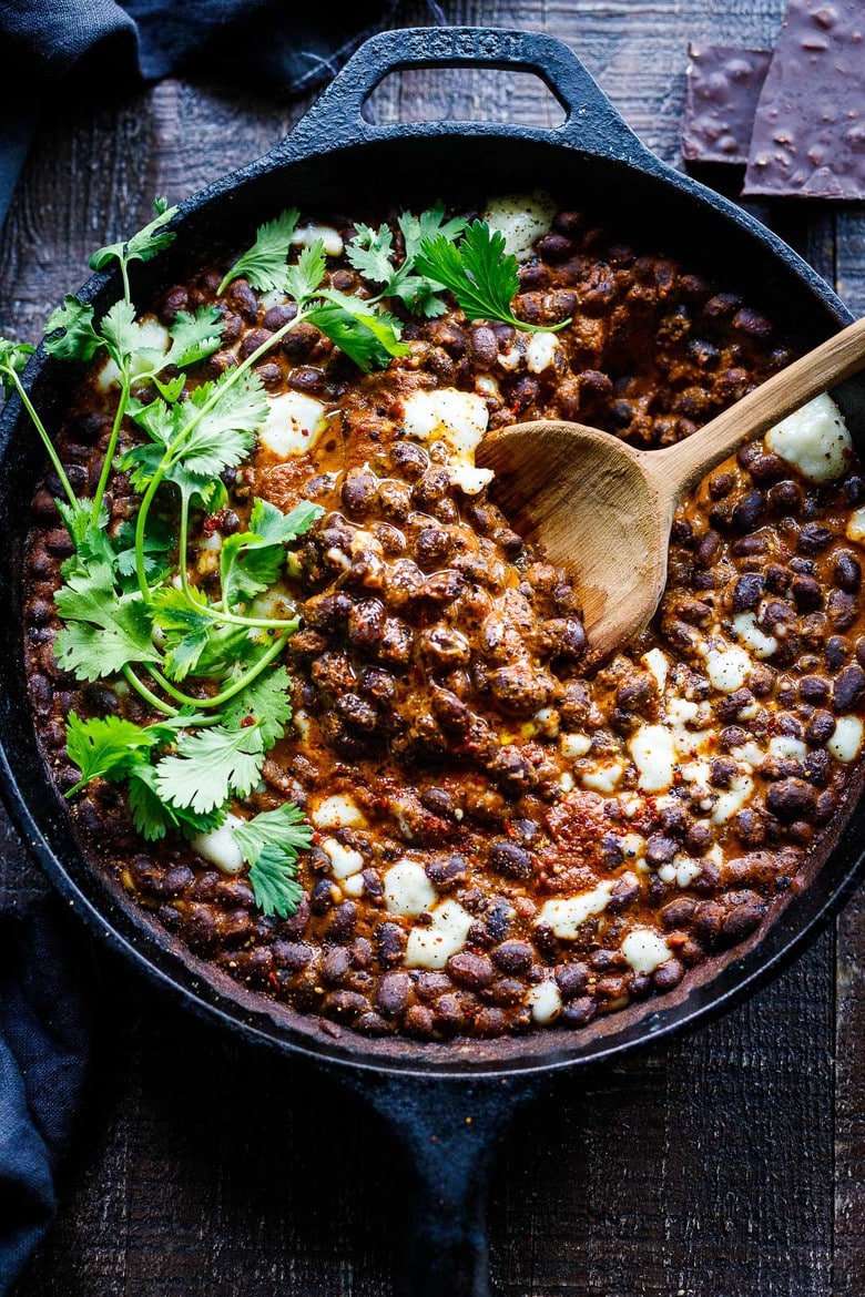 Savory Black Beans baked in a quick and easy Mexican Mole Sauce topped with queso fresco cheese (optional)- serve this as a delicious side dish for your Mexican Fiesta or as a flavorful base for healthy bowls. 