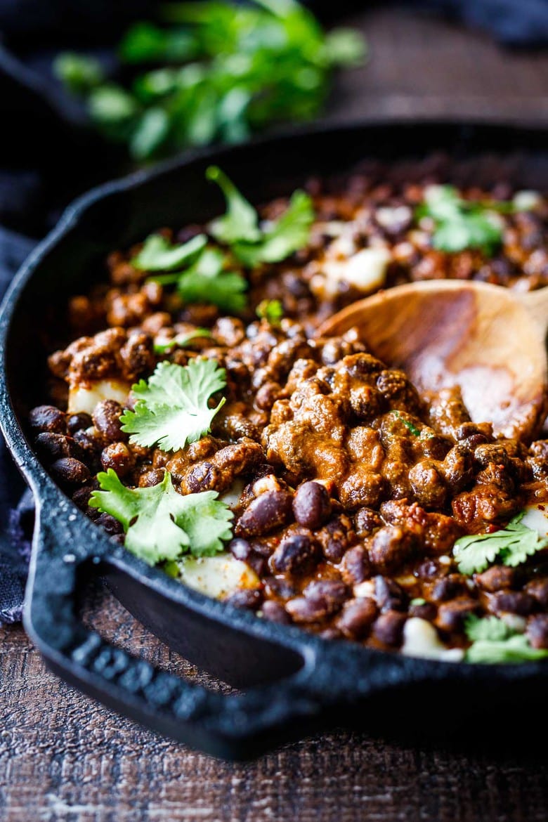 Savory Black Beans baked in a quick and easy Mexican Mole Sauce topped with queso fresco cheese (optional)- serve this as a delicious side dish for your Mexican Fiesta or as a flavorful base for healthy bowls.