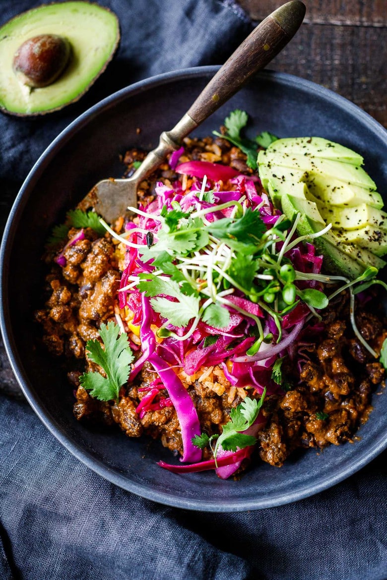 Savory Black Beans baked in a quick and easy Mexican Mole Sauce topped with queso fresco cheese (optional)- serve this as a delicious side dish for your Mexican Fiesta or as a flavorful base for healthy bowls. 