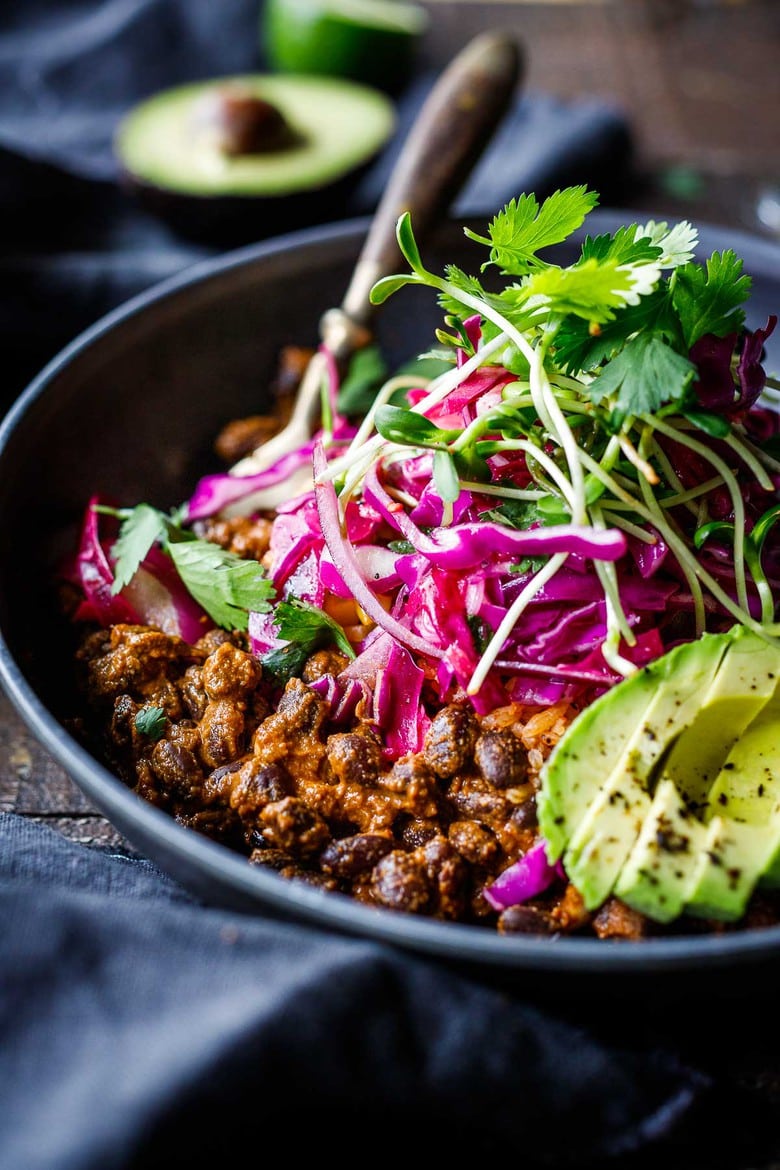 Savory Black Beans baked in a quick and easy Mexican Mole Sauce topped with queso fresco cheese (optional)- serve this as a delicious side dish for your Mexican Fiesta or as a flavorful base for healthy bowls.