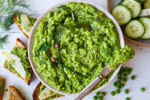 Quick and easy to make, this Spring Pea Pesto is deliciously vibrant with fresh herby flavor.  Perfect for a dip, spread or use as a sauce with pasta and buddha bowls.  Vegan and gluten free!