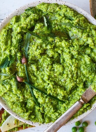Quick and easy to make, this Spring Pea Pesto is deliciously vibrant with fresh herby flavor.  Perfect for a dip, spread or use as a sauce with pasta and buddha bowls.  Vegan and gluten free!