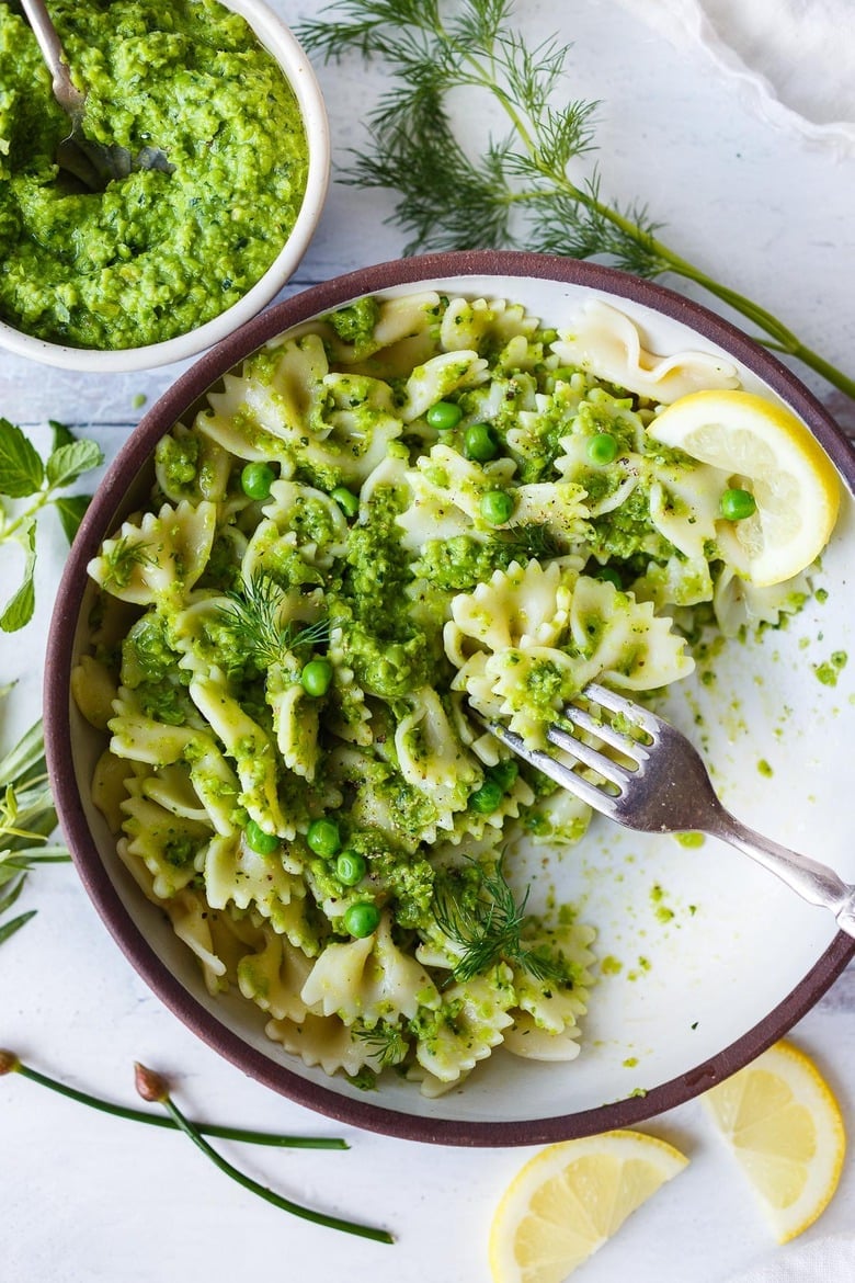 Quick and easy to make, this Spring Pea Pesto is deliciously vibrant with fresh herby flavor.  Perfect for a dip, spread or use as a sauce with pasta and buddha bowls.  Vegan and gluten free!