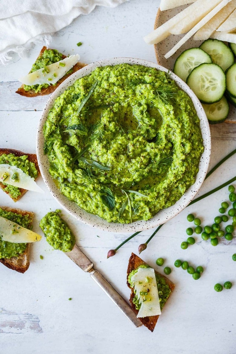 Quick and easy to make, this Spring Pea Pesto is deliciously vibrant with fresh herby flavor.  Perfect for a dip, spread or use as a sauce with pasta and buddha bowls.  Vegan and gluten free!