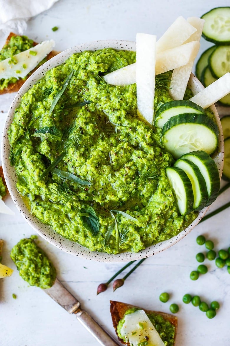35+ Best Potluck Ideas| Quick and easy to make, this Spring Pea Pesto is deliciously vibrant with fresh herby flavor.  Perfect for bringing to a potluck- it can be used as dip, spread or use as a sauce and so versatile it pairs well with many things. Vegan and gluten-free!