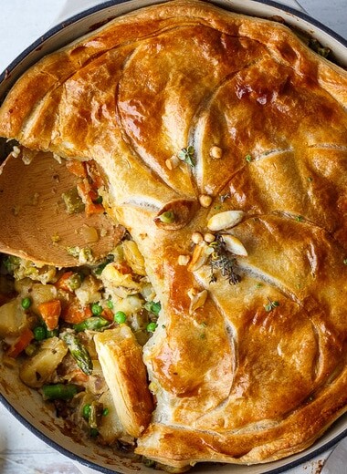 This Vegan Pot Pie is loaded with vibrant fresh spring veggies and flavorful herbs cooked in a creamy lemon mustard sauce topped with a flakey puff pastry crust.
