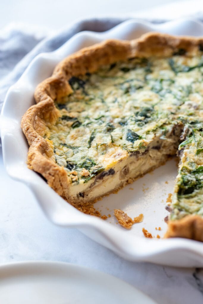 Quiche in a white baking dish.