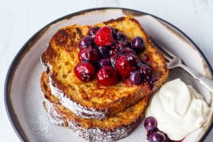 An easy recipe for tender French Toast enhanced with spices, orange zest, and lightly sweetened with maple syrup.  Top with Fresh Berry Compote for a perfect weekend breakfast treat.