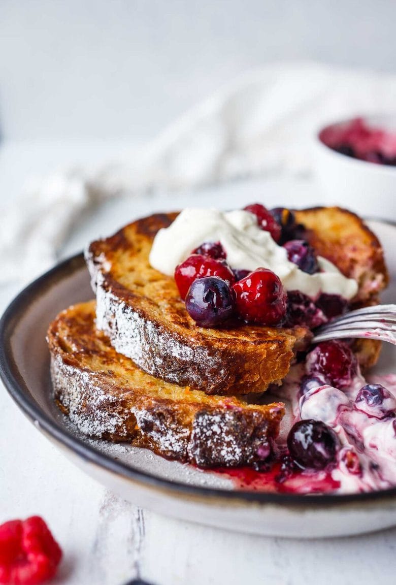 An easy recipe for tender French Toast enhanced with spices, orange zest, and lightly sweetened with maple syrup.  Top with Fresh Berry Compote for a perfect weekend breakfast treat.
