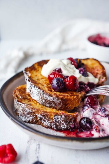 An easy recipe for tender French Toast enhanced with spices, orange zest, and lightly sweetened with maple syrup.  Top with Fresh Berry Compote for a perfect weekend breakfast treat.