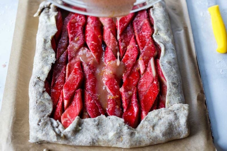 pouring sugar mixture over tart