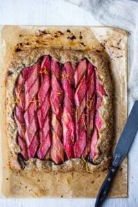 A rustic Rhubarb Tart with lemon, cardamom and vanilla tucked into a flakey free-form buckwheat crust.  Simple, elegant, and delicious!