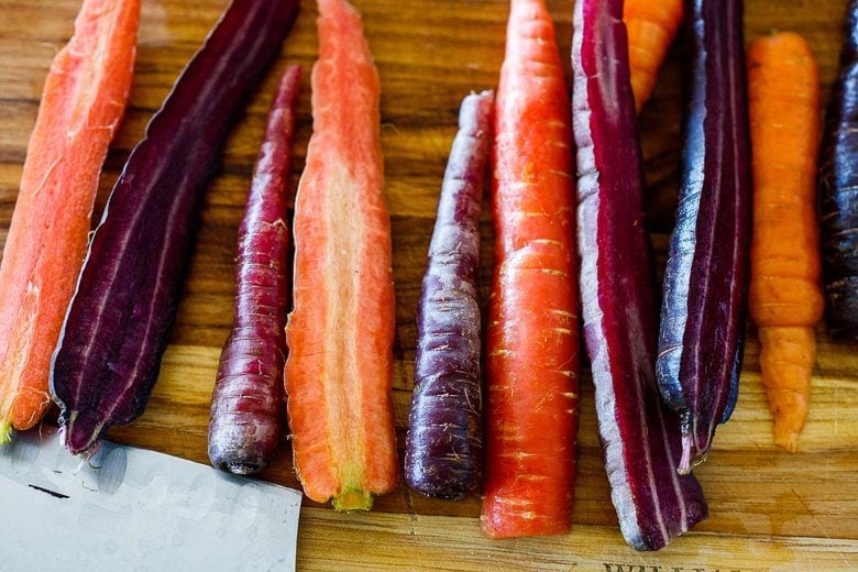 prepping the carrots on a cutting board