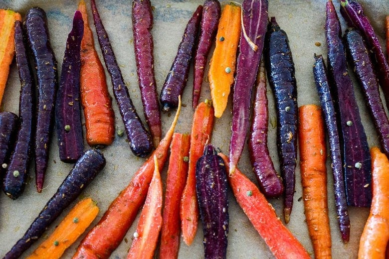 seasoned carrots on a sheet pan